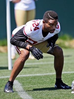 San Francisco 49ers cornerback Nnamdi Asomugha, released after two horrible season with the Philadelphia Eagles, stretches during training camp Thursday.