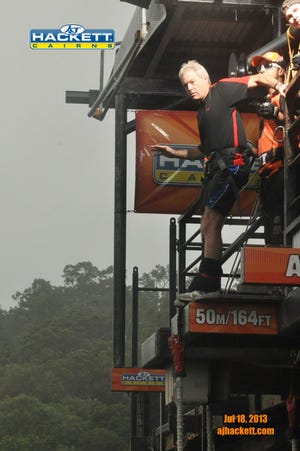 Columnist Mark Patinkin tries to let go of the railing to make his bungee jump in Cairns, Australia.