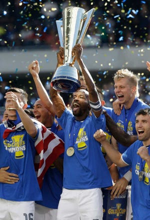 United States DaMarcus Beasley, center, holds the trophy as he celebrates with teammates after defeating Panama 1-0 during the CONCACAF Gold Cup final soccer match at Soldier Field on Sunday, July 28, in Chicago.