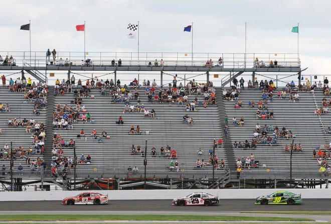 Sprint Cup Series driver David Reutimann (83), Kevin Harvick (29) and David Stremme (30) steer their cars during the Brickyard 400 on Sunday at the Indianapolis Motor Speedway in Indianapolis, Sunday, July 28, 2013. (AP Photo/Doug McSchooler)