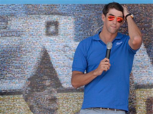 Former Olympic and world swimming champion Michael Phelps of the US attends the unveiling of a mosaic installed in his honour at the FINA Swimming World Championships in Barcelona, Spain, Sunday, July 28, 2013.