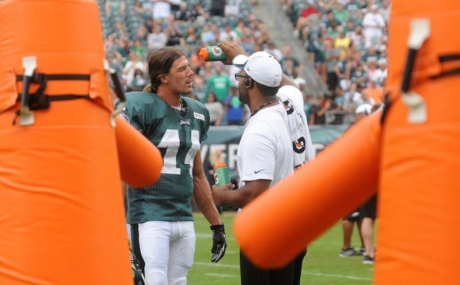 Eagles wide receiver Riley Cooper (14) cools off with a trainer during the Eagles' July 28 training camp practice at the Linc.