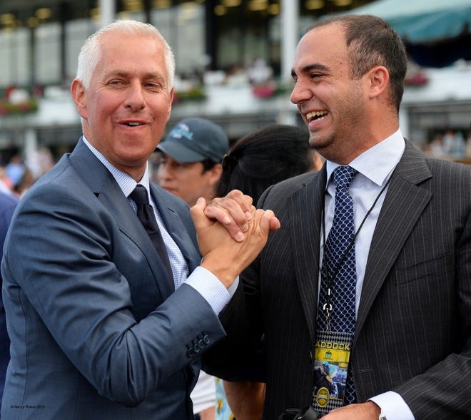 A jubliant Todd Pletcher (l) shakes hands with one of the owners of Verrazano after the three year-old colt won the $1-million William Hill Haskell Invitational (GR I) by 9 3/4 lengths going 1 1/8 miles.