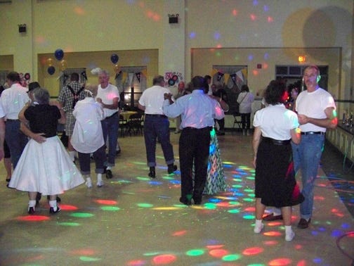 Patrons dance to the music provided by DJ Tony at the July 20 St. Gerard Campus benefit sock hop
