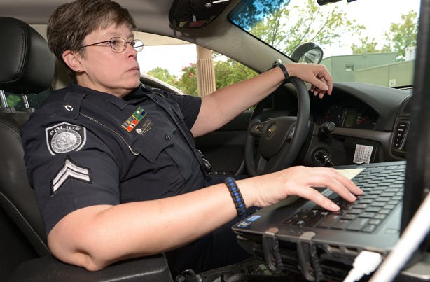 Burlington Police Department Cpl. Kris Grayson inside her vehicle at the police department Tuesday.