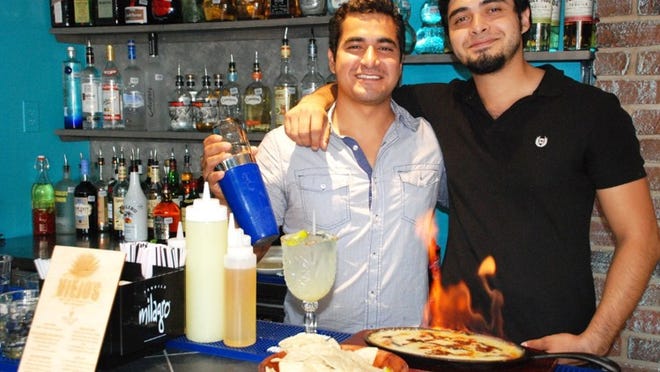 Siblings and co-owners of Viejo’s Tacos y Tequila, Joe and Danny Oviedo, serve up 100 percent agave nectar margaritas and an assortment of menu items, including tasty tacos and las botanas. SARAH ACOSTA/ AUSTIN COMMUNITY NEWSPAPERS