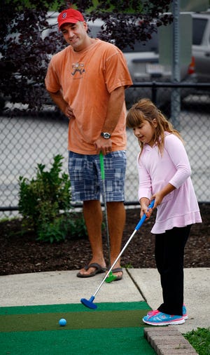 .Noey Giardina, 6, and her dad, Joe, of Hanover play a round of miniature golf course at the newly reopened Star Land on Route 53 in Hanover.