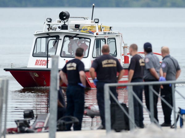 A Morgan County Rescue Squad boat pulls into Ingalls Harbor Tuesday, July 30, 2013 where emergency personnel were waiting after a man was killed on the Tennessee River Tuesday evening when he was struck in the head by a low hanging power line while he was traveling in a fishing boat. (AP Photo/The Decatur Daily, Gary Cosby Jr.)
