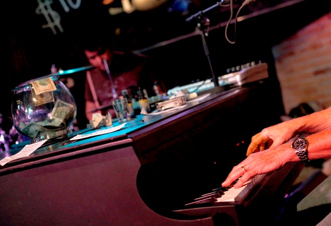 John Sackett's hands are seen playing a song at Rockey's Dueling Piano Bar in Gainesville in 2012. On Saturday, Aug. 3, the Coyote Cantina in Ocala will bring in dueling pianos from Orlando for a night of duelmanship on a pair of baby grand pianos trucked in just for this event.