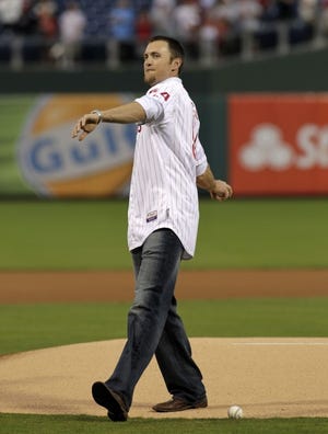 Former Phillies pitcher Brad Lidge throws the first pitch Thursday in Philadelphia. He retired Thursday as a Phillie.