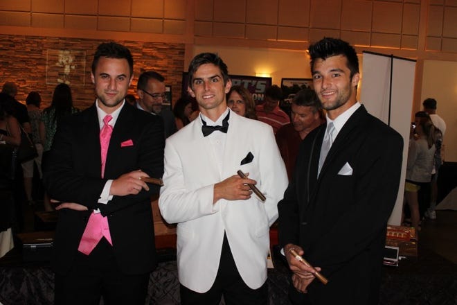 Models (from left) Joseph Pellicore, Daniel Halgas and Nicholas Lafranchi pose at the Smoking Dog Cigar table at the His and Hers wedding event at The Madison in Riverside.