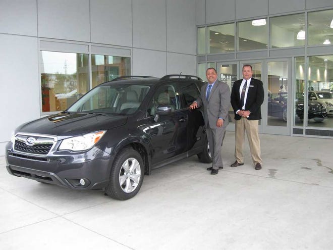 Barbara.Gavan@jacksonville.com Consumer Reports named the 2014 Subaru Forester - shown here with Jack Hanania, president and CEO of Hanania Automotive Group (left), and Stuart Jones, general manager of Subaru of Orange Park - its top-rated small SUV.