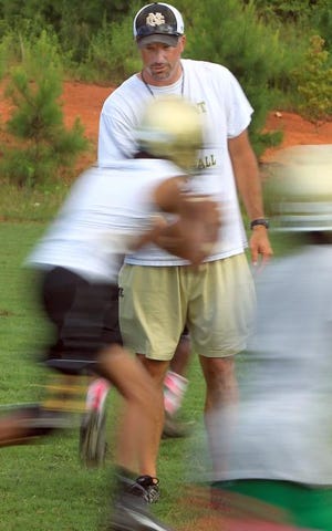 North Gaston head coach Mike Patton works with his players at Thursday's practice.