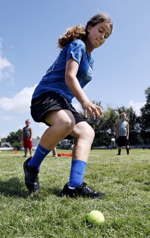 Rosie Gatch, 14, chases a ball during a speed and agility camp sponsored by the Norman Parks and Recreation Department. PHOTO BY STEVE SISNEY, THE OKLAHOMAN STEVE SISNEY