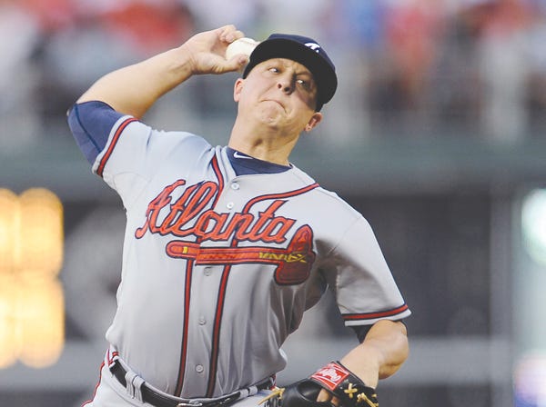 Atlanta pitcher Kris Medlen throws a pitch during the first inning of a game against Philadelphia on Friday. (Michael Perez | Associated Press)
