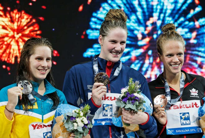 From left: Australia's Belinda Hocking, silver, Missy Franklin of the United States. gold, and Canada's Hilary Caldwell, bronze, smile as they hold their medals during the presentation ceremony for the Women's 200m backstroke final on Saturday at the FINA Swimming World Championships in Barcelona. (AP Photo/Michael Sohn)