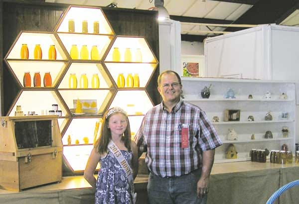 Submitted photo - The 2013 Honey Queen, Chrissy Perez, and contest judge Tim Schuler, New Jersey state apiarist, stand with the winning entries from the Honey Show.