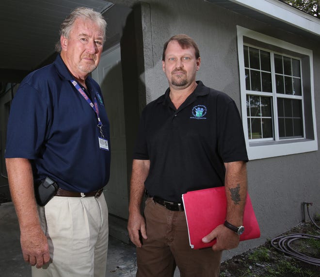 Richard Luger, a senior child protective investigator with the Department of Children and Families, left, stands next to Mat Graber, a child protective investigator with DCF, in northeast Ocala.