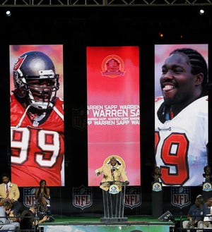 Warren Sapp speaks during the induction ceremony at the Pro Football Hall of Fame on Saturday in Canton, Ohio.
