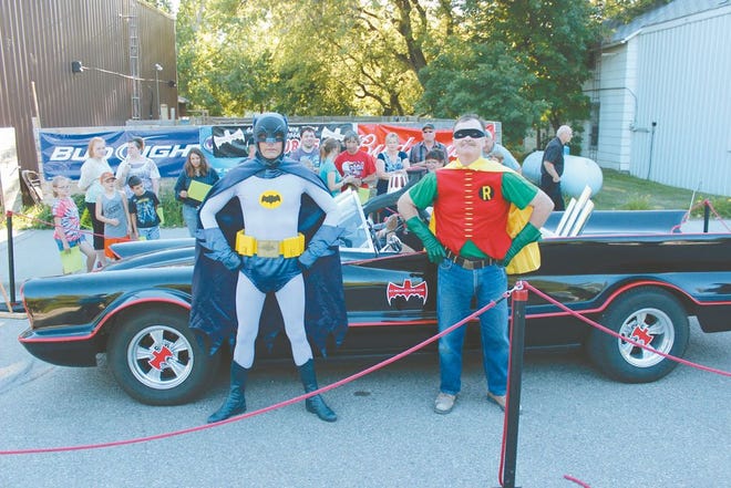 Clint Young (Batman) and Pekin mayor Steve Girodat (Robin) stand proudly in front of the original Batmobile during it’s brief appearance in Pekin this weekend.