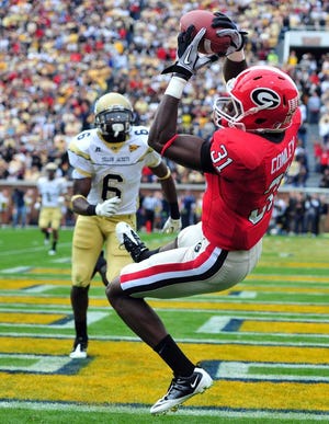 Brant Sanderlin Atlanta Journal-Constitution  Georgia's Chris Conley pulls in a touchdown pass in front of Rod Sweeting of Georgia Tech last November in Atlanta.
