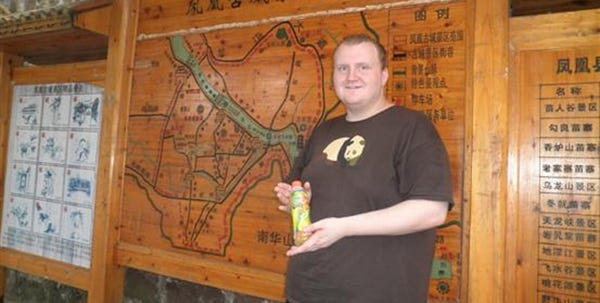 Jon Albeck pauses at a map display in China.