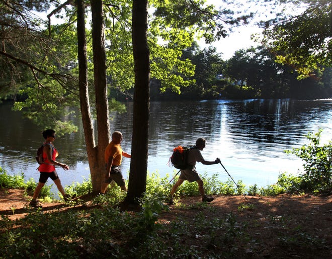 Bob Tessitore, of Greenville, leads the way as the hikers head along Stump Pond in Smithfield. Behind him are Ken Pontrelli, of Brooklyn, Conn., and Jerilyn Spaziano, of Johnston. The Rhode Island Hiking Club offers walks for all fitness levels at locations throughout the state.