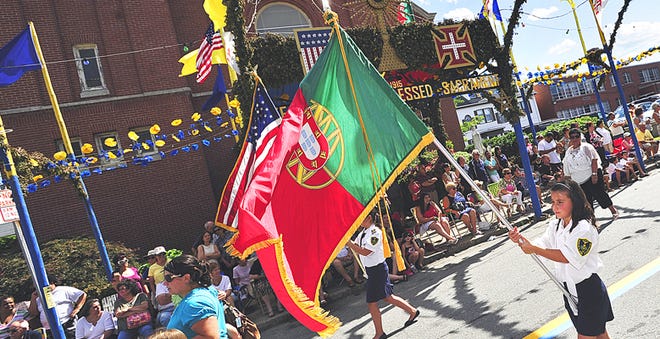 The proud Portuguese flag flies high as it moves down Earle Street during the Feast parade.