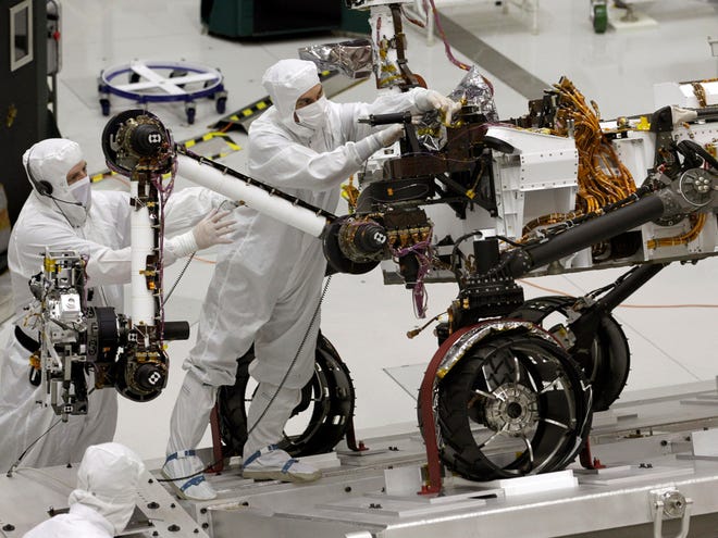 This Sept. 16, 2010 file photo shows engineers working on the Mars rover Curiosity at NASA's Jet Propulsion Laboratory in Pasadena, Calif.