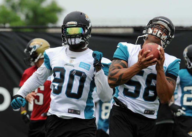 Bob.Mack@jacksonville.com The Jaguars' Jason Babin (58) catches a ball in front of Andre Branch during the team's Organized Training Activities on May 20.