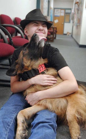 Terry.Dickson@jacksonville.com Bronx licks Chris Carswell's face at Satilla Marsh Elementary, where Chris suffered a near fatal seizure in 2007. Bronx is Chris' service dog.