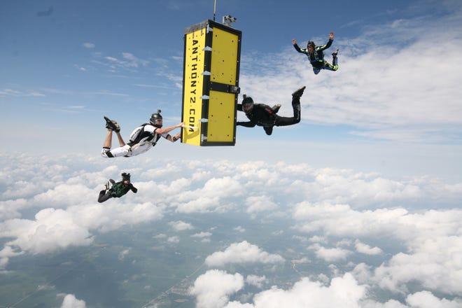 In this photo provided by Skydive Chicago, escape artist Anthony Martin falls while handcuffed and locked inside a box after being dropped from an airplane over Ottawa, Ill., Tuesday, Aug. 6, 2013. (AP Photo/Courtesy of Skydive Chicago, Joe Silva)