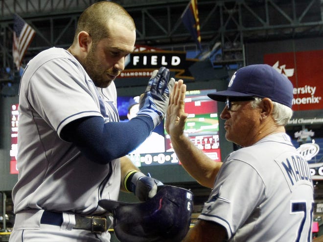 Tampa Bay Rays third baseman Evan Longoria (3), left, celebrates with Joe Maddon (70) after hitting a solo homerun against the Arizona Diamondbacks in the fourth inning during a baseball game on Tuesday in Phoenix.