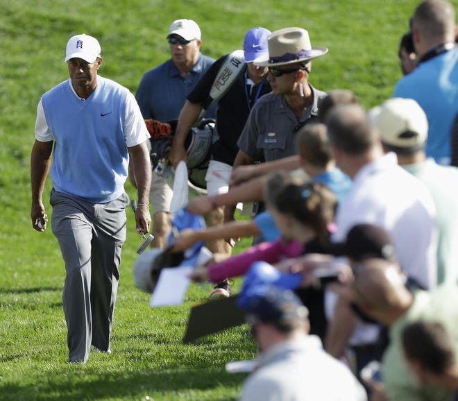 Tiger Woods walks to the 16th tee during a practice round for the PGA Championship golf tournament at Oak Hill Country Club on Tuesday in Pittsford, N.Y.
