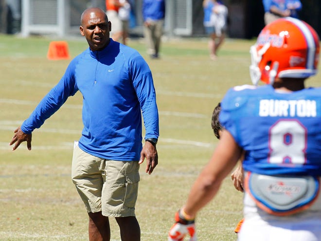 Florida wide receivers coach Joker Phillips instructs players during a drill in the spring.