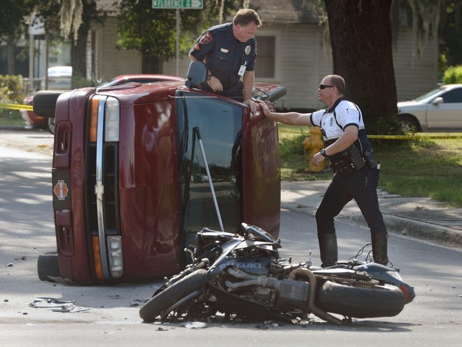 Lakeland police officers investigate a traffic fatality at Martin Luther King, Jr. Avenue and Emma Street in Lakeland Wednesday morning.