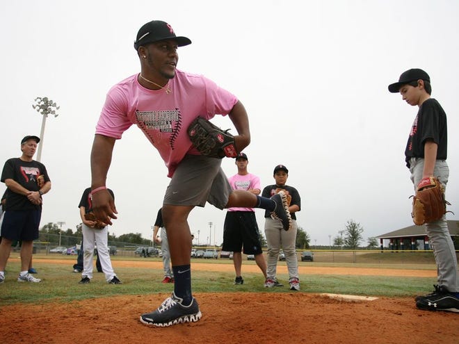 Former Forest High School pitcher Keyvius Sampson coaches children attending a baseball clinic at the Rotary Sportsplex on Saturday, Dec. 8, 2012, in Ocala.