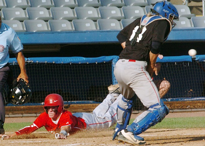 The Connecticut Bulldogs' Brendan Johnson is safe in a head-first slide at home as the Connecticut Heat's James Annello gets the late throw Tuesday during the Chris Potvin Tournament at Dodd Stadium in Norwich.