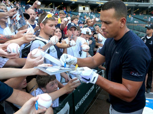New York Yankee third baseman Alex Rodriguez signs autographs before Wednesday night's game against the Chicago White Sox in Chicago. (Charles Rex Arbogast | Associated Press)