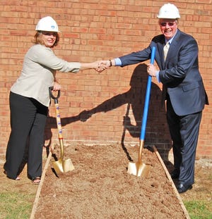 Bucks County Community College President Dr. Stephanie Shanblatt (left) and PECO President and CEO Craig Adams (right) break ground August 5 to celebrate bringing natural gas service to the college’s Newtown Campus. Contributed Photo