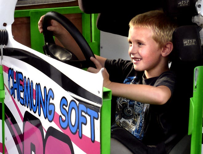 Brock Perry, 6, of Greenwood, sits in Alexandria Smith's race car she drives at the Chemung Speedrome while at Race Fever Thursday in Corning.