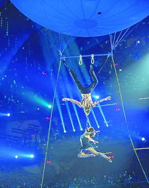Nathon Deets, top, supports a twirling Alexandra Nock with only a strap 
connecting their necks as they float under the Aerosphere Aerial Balloon 
while competing on "America's Got Talent."
PHOTO / NBC
