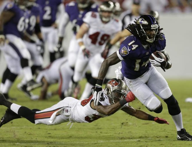 Baltimore Ravens wide receiver Marlon Brown (14) runs past Tampa Bay Buccaneers defensive back Branden Smith during an NFL preseason football game Thursday, Aug. 8, 2013, in Tampa, Fla.