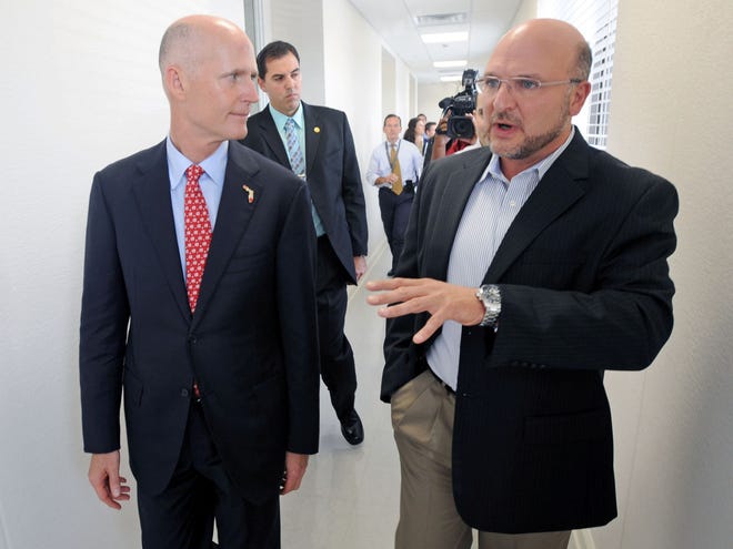 Florida Gov. Rick Scott takes a tour of SteriPack with SteriPack President Tony Paolino in Lakeland on Friday.