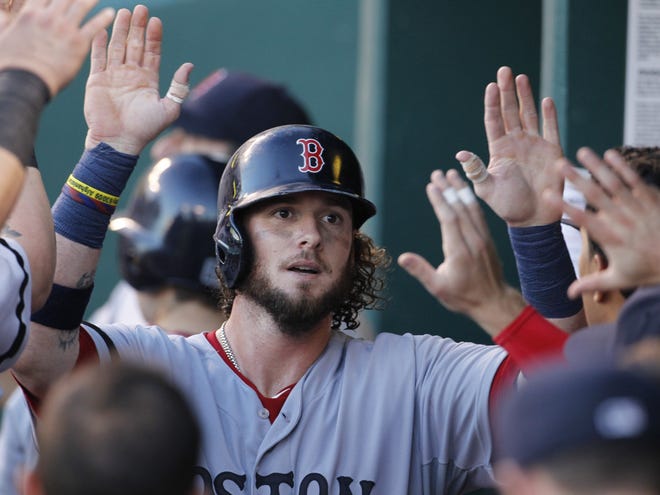 Jarrod Saltalamacchia is congratulated in the dugout after scoring on a Will Middlebrooks single in the fourth inning of of the Red Sox' 5-3 victory over the Royals on Saturday night in Kansas City.