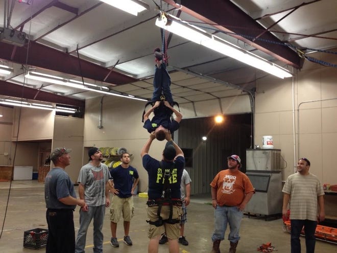 Pictured: (L to R) are – St. Amant Members Jai Denham, Jeremy Duhe, Mytrial Whitehead, Donnie Hebert, Justin Devall and Josh Wingerter demonstrate with Junior Firefighter Broc Poche the different lifting techniques in Confined Space Rescue