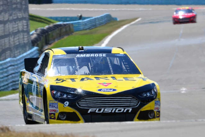 Marcos Ambrose (9) drives during qualifying for Sunday's NASCAR Sprint Cup Series auto race, Saturday Aug. 10, 2013, in Watkins Glen, N.Y. Ambrose took the pole with 128.241 miles per hour. (AP Photo/Tom Ryder)