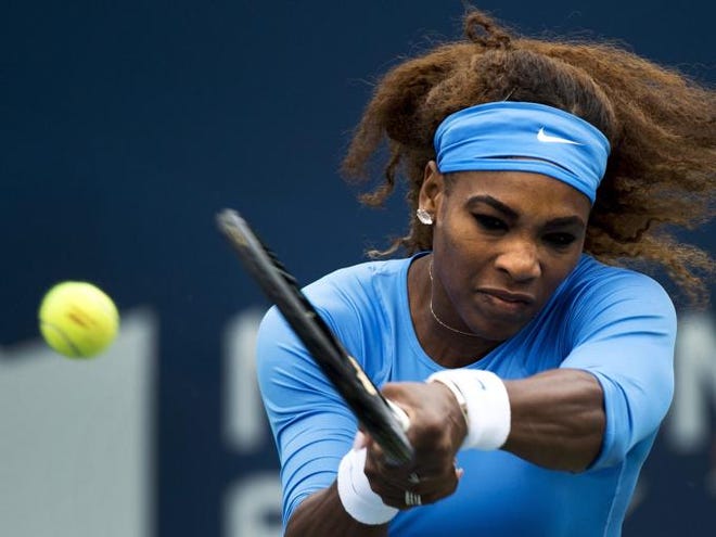 Serena Williams, of the United States, returns the ball against Sorana Cirstea, of Romania, during the women's singles championship at the Rogers Cup tennis tournament in Toronto, Sunday, Aug. 11, 2013. (AP Photo/The Canadian Press, Nathan Denette)