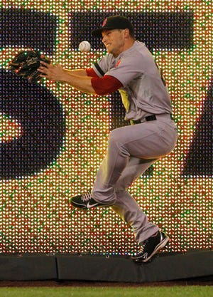 Boston Red Sox right fielder Daniel Nava is unable to hold on to a fly ball from Kansas City Royals' Brett Hayes in the eighth inning of a baseball game at Kauffman Stadium in Kansas City, Mo., Saturday, Aug. 10, 2013. ()