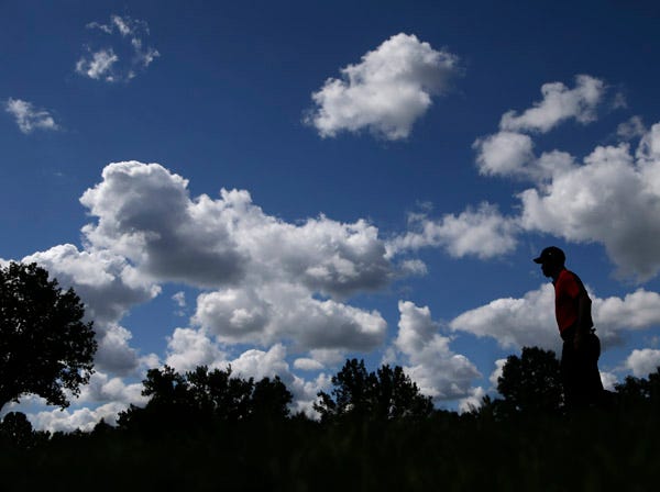 Tiger Woods walks to the fourth tee during Sunday's final round of the PGA Championship.
(Charlie Neibergall | Associated Press)